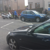Motorcyclist on pavement hit by car